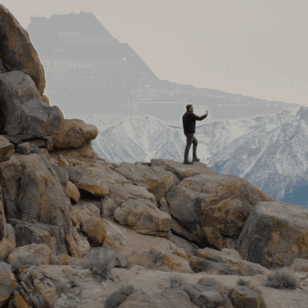 Person holding a phone in a remote location